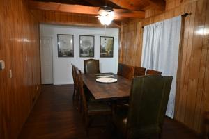 a dining room with a wooden table and chairs at Bear House in Big Bear City