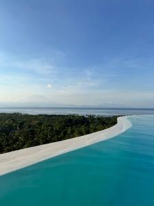 an aerial view of a beach and the ocean at Penida View Village - Infinity pool & Volcano View in Nusa Penida