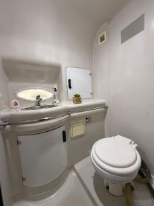 a small bathroom with a toilet and a mirror at Barco la bella in Vigo