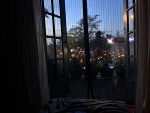 a room with a window with a view of a garden at Historic Retreat in Detroit