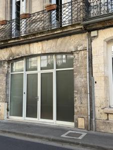 a building with large windows on the side of it at Argence logement T2 in Angoulême