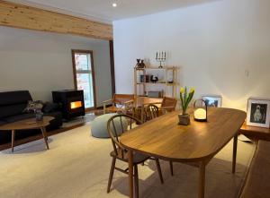 a living room with a table and a couch at My Chalet Hakuba in Hakuba