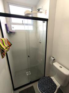 a glass shower in a bathroom with a toilet at Apartamento bem confortável in Maceió +28 photos