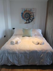 a bedroom with a bed with towels on it at Ammonite Playa in Mar del Plata