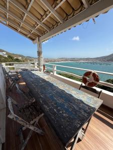 a table on a deck with a view of the water at Hospedagem pontal do atalaia in Arraial do Cabo