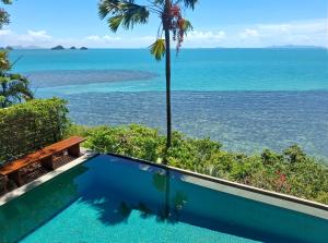 a swimming pool with a view of the ocean at The Headland Villa 2, Samui in Koh Samui