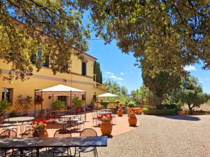 a patio with tables and chairs and a building at Spacious Holiday Home in Radicofani in Celle sul Rigo