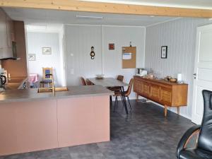 a kitchen with a counter and a table and chairs at 4 person holiday home in TANA in Tana +21 photos