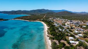 an aerial view of a beach with houses and the ocean at "Tranquillity by the Sea" your Hideaway Bay Holiday Rental-Whitsundays in Hideaway Bay +9 photos