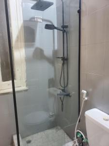 a shower with a glass door in a bathroom at nice comfy bedroom in Cairo