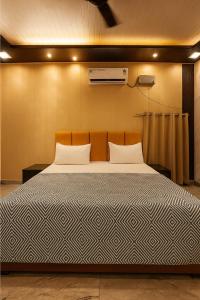 a large bed in a room with at The Family Palace in Ayodhya