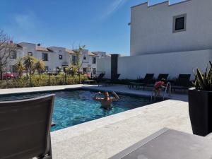 a man in a swimming pool in a house at Casa de Descanso in La Cañada