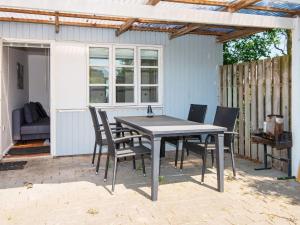 a table and chairs sitting on a patio at Seaside Escape in Kegnaes - By Traum Ferienwohnungen in Østerby