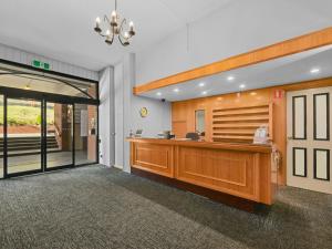 a lobby with a reception desk in a building at Commodore Regent Launceston in Launceston