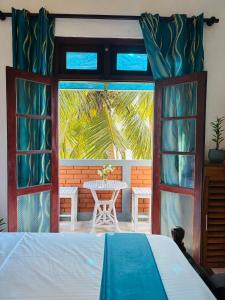 a bedroom with a bed and a table and a window at SENUKi in Galle +31 photos