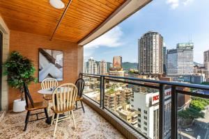 a balcony with a table and chairs and a view of the city at Jinxin Nanguo in Chongqing