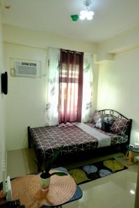 Postel nebo postele na pokoji v ubytování Cecils Cubao Cozy Escape