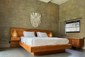 a bedroom with a bed and a chandelier at Uluwatu Villa Special Price Aug, Sept, Oct in Ungasan