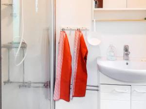 a bathroom with orange towels hanging next to a sink at 4 person holiday home in BRAÅS-By Traum in Braås +20 photos