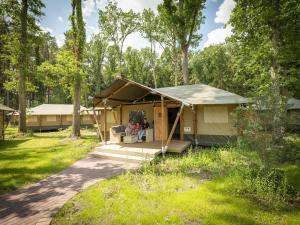 a couple sitting in a tent in a yard at Luxuszelt im Serengeti Park in Hodenhagen