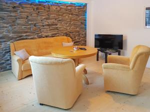 a living room with couches and a table and chairs at Ferienwohnung in Wildemann in Wildemann
