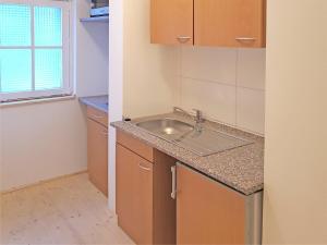 a small kitchen with a sink and a window at Ferienwohnung im Oberharz in Wildemann in Wildemann