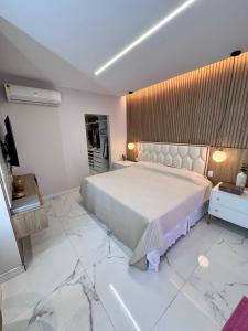a bedroom with a large bed and marble floors at Cop30 - casa de luxo no cidade jardim 2 in Belém