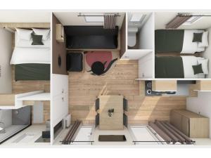 a floor plan of a room with two beds at Mobil-home confortable 4 personnes - API-1-52-481 in La Mothe-Achard