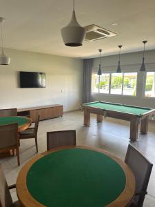 a billiard room with a table and ping pong at Village Ducado in Mangaratiba