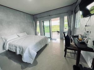 Ένα ή περισσότερα κρεβάτια σε δωμάτιο στο Himmuang Homestay