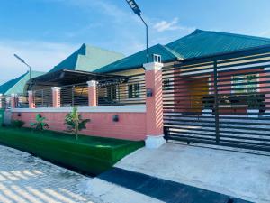 a house with a fence around it at Chizzy Shortlets in Warri