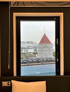 a bedroom window with a view of a building at HOTEL TAVINOS Hamamatsucho - Vacation STAY 51014 in Tokyo