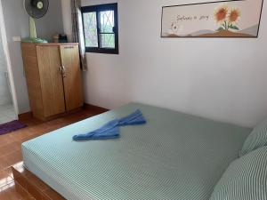 a bedroom with a bed with a blue shirt on it at Lonely Beach Pool Resort in Ko Chang +22 photos