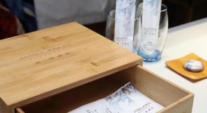 eine Holzkiste mit zwei Gläsern auf einem Tisch in der Unterkunft James Joyce Coffetel Zhengzhou CBD Exhibition Center Provincial People's Hospital in Zhengzhou