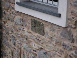 a window on a stone wall with a window sill at Casa Natale in Corvara