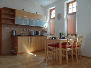 a kitchen with a table and chairs in a room at Apartament Selaz in Szklarska Poręba