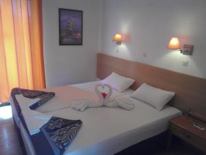 Postel nebo postele na pokoji v ubytování Amfi Apartments