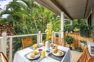 a table with plates of food on a balcony at Premier Collection at Grand Champions Wailea - Limited-Time Half Off in Wailea