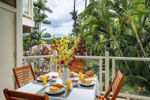a table with breakfast food on a balcony at Premier Collection at Grand Champions Wailea - Limited-Time Half Off in Wailea