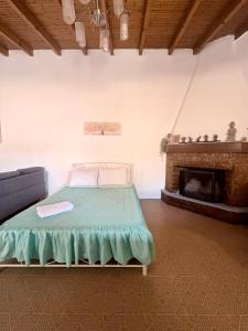 a bed in a room with a fireplace at Aμvrosia Avramio Village - Fireplace, Free WiFi, Pet Friendly in Avramión