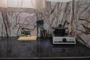 a kitchen with a stove with a pot on it at AmoreBay in Mirissa