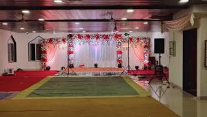a large room with a stage with a stagength at Hotel Sandesh Palace Lonavala in Lonavala