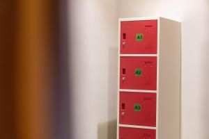 a shelf with red and green boxes at Pondok Tis Bisma in Ubud