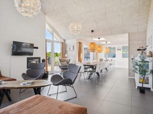 a dining room and living room with a table and chairs at 5 star holiday home in Glesborg in Glesborg