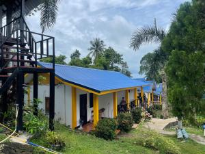 a house with a blue roof and a porch at Lonely Beach Pool Resort in Ko Chang
