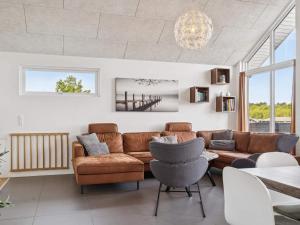 a living room with a couch and a table at 5 star holiday home in Glesborg in Glesborg