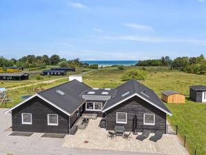an aerial view of a house with the ocean in the background at 20 person holiday home in Glesborg in Glesborg