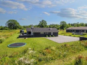 an aerial view of a house with a putting green at 20 person holiday home in Glesborg in Glesborg