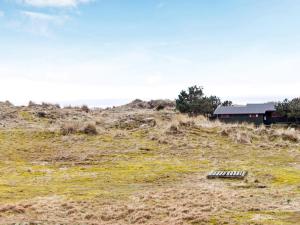 a building sitting on top of a grassy hill at 7 person holiday home in Fanø-By Traum in Fanø