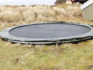 an empty trampoline in the middle of a field at 7 person holiday home in Fanø-By Traum in Fanø